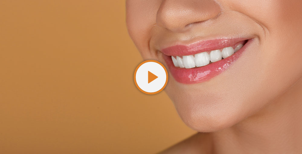 patient smiling after teeth whitening procedure